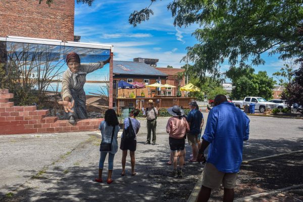 MD Harriet Tubman Underground Railroad Nat Hist Park - Ranger talks in front of Harriet Tubman Mural - NPS